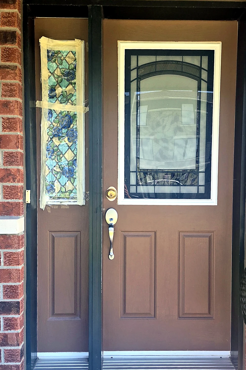 Front door with damaged glass in Ottawa, prepped for a new tempered glass replacement