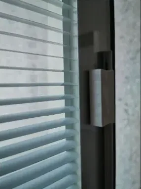 Slider that tilts blinds sealed between the glass