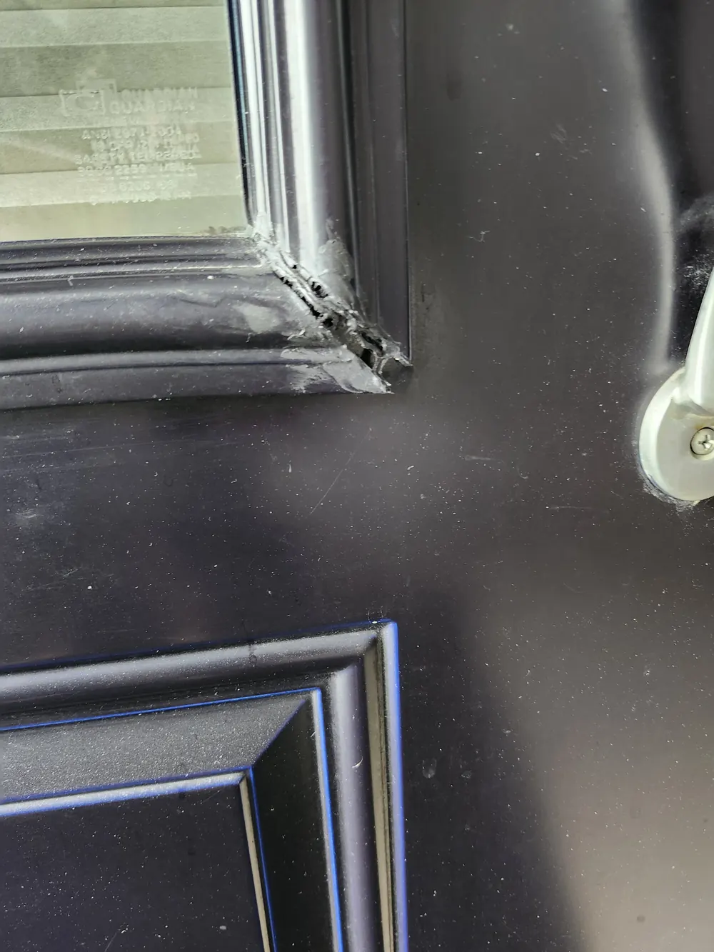 Door glass frame moulding on an Ottawa front door showing sun and age damage