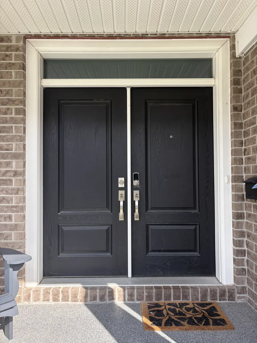 Black double doors with solid panels before glass, Ottawa